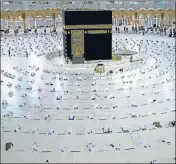  ?? AFP ?? Worshipper­s in socially distanced positions perform a prayer in the Grand Mosque complex in Mecca, Saudi Arabia.