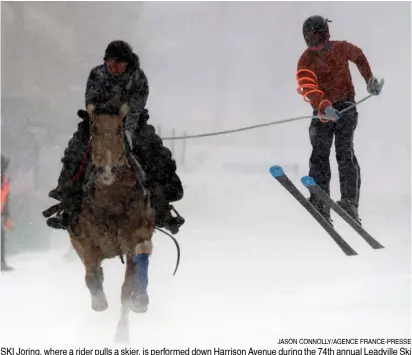  ?? JASON CONNOLLY/AGENCE FRANCE-PRESSE ?? SKI Joring, where a rider pulls a skier, is performed down Harrison Avenue during the 74th annual Leadville Ski Joring weekend competitio­n in Leadville, Colorado, USA. In the competitio­n, the rider and skier must navigate jumps and slalom gates, and spear rings for points.