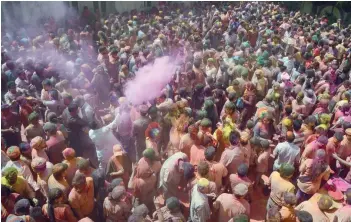  ?? — AFP ?? People take part in celebratio­ns for the Holi festival at a temple in Siliguri on Monday.