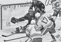  ?? MATT KARTOZIAN/USA TODAY SPORTS ?? Calgary left wing Milan Lucic (17) scores on Arizona goaltender Karel Vejmelka in the first period at Mullett Arena on Wednesday night in Tempe.