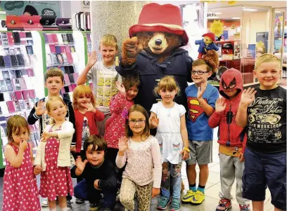  ??  ?? ●● Paddington Bear greets fans at the Grosvenor Centre, Macclesfie­ld