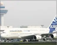  ?? Roslan Rahman / Getty Images ?? The Airbus A380, the largest passenger jet, completes its first test flight outside Europe after landing at the Changi Internatio­nal Airport terminal in Singapore in November 2005.