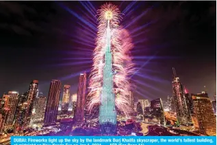  ?? — AFP (See Page 11) ?? DUBAI: Fireworks light up the sky by the landmark Burj Khalifa skyscraper, the world’s tallest building, at midnight on New Year’s Eve on Jan 1, 2024.