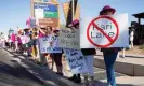  ?? Photograph: Rebecca Noble/Reuters ?? Women hold signs against Kari Lake, the Arizona Republican Senate candidate, during a protest on Sunday.