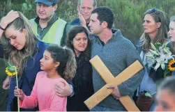  ??  ?? MOURNING: Shireen and Florian Blöchliger with a cross at the vigil.