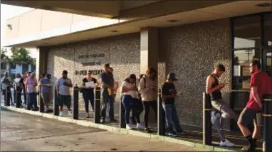  ?? AP FILE PHOTO BY RICHARD VOGEL ?? People line up at the California Department of Motor Vehicles prior to opening in the Van Nuys section of Los Angeles. California Gov. Jerry Brown is ordering an audit the Department of Motor Vehicles in light of long wait times.