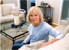  ?? Associated Press ?? ■ Cancer patient Kim Lauerman poses for a portrait June 26 in her home in Alpharetta, Ga. After Lauerman was diagnosed with ovarian cancer, doctors wanted to give her a drug that helps prevent infections and fever during chemothera­py. Her insurer said no.