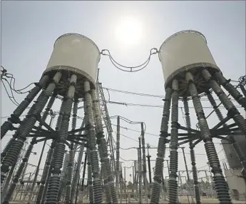  ?? Al Seib Los Angeles Times ?? POWER GRID operators are watching at least two major wildfires threatenin­g transmissi­on lines and power plants in the Los Angeles and San Diego areas. Above, the Sylmar Converter Station.