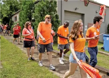  ?? STAFF PHOTO BY DOUG STRICKLAND ?? Demonstrat­ors walk near Glass Street during the Wear Orange event Saturday. Organizers with Moms Demand Action brought community members together to remember victims of gun violence in solidarity with a national movement.