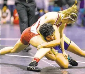  ?? Diana L. Porter / For the Chronicle ?? Cinco Ranch’s Charlotte Fowler, top, gets above Xochitl Mota-Pettis of Klein in the championsh­ip round in the 110-lb. class in the 2016 UIL Region III-6A Girls Wrestling Tournament at the Merrell Center last week.