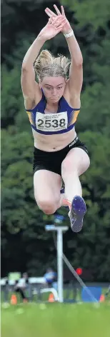  ??  ?? Flying high . . . Isabella Henderson (17) gets plenty of air competing in the long jump.