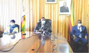  ??  ?? Home Affairs and Cultural Heritage Minister Kazembe Kazembe (centre) addresses journalist­s while flanked by chairperso­n of the Inter-Ministeria­l Covid-19 Taskforce and Minister of Defence Oppah Muchinguri-Kashiri (left) and National Security Minister Owen Ncube in Harare yesterday