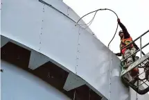  ?? Christian Abraham/Hearst Connecticu­t Media ?? A crew member from CSB Communicat­ions of Branford works to upgrade Verizon wireless equipment atop the 130-foot water tower at Waveny Park in New Canaan on Oct. 17.