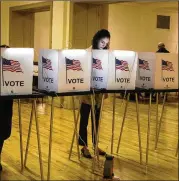  ?? BRITTANY GREESON/THE NEW YORK TIMES ?? Brie Riley, 23, fills out her primary ballot Tuesday in a polling place set up at the Central United Methodist Church in downtown Detroit, at the center of the battle for Michigan voters.