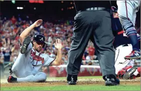  ?? SUSAN WALSH / The Associated Press ?? Atlanta’s Charlie Culberson slides home for a run during the fifth inning of Friday’s game against the Washington Nationals.