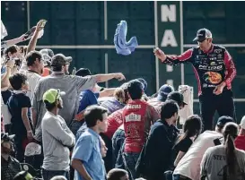  ??  ?? Kevin VanDam, who finished 10th, tosses an autographe­d T-shirt to fans during the Bassmaster­s Classic final-day weigh-in at Minute Maid Park.