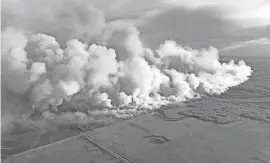  ?? HANDOUT/ALBERTA WILDFIRE SERVICE/AFP VIA GETTY IMAGES ?? Wildland firefighte­rs backed by helicopter­s and airtankers continue to battle a growing blaze in Western Canada as thousands evacuate British Columbia.