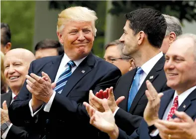  ?? THE ASSOCIATED PRESS ?? President Donald Trump and House Speaker Paul Ryan of Wisconsin grin broadly in the White House Rose Garden on Thursday after the House pushed through a health care bill. House Majority Whip Steve Scalise of Louisiana is at left, and House Ways and...