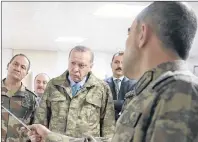  ?? AP PHOTO ?? Turkey’s President Recep Tayyip Erdogan, second left, is briefed by a Turkish Army officer at the command center at the command centre in Hatay province at the Turkish-Syrian border Thursday.