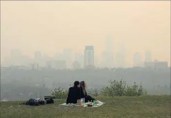  ?? Jason Franson Canadian Press ?? SMOKE blankets the skyline of Edmonton, Canada, on Saturday. Nearly 90 wildfires are currently burning in Canada, including one near Fort Nelson in northeaste­rn British Columbia that’s forced evacuation­s.