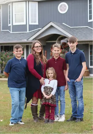  ?? PHOTO BY KATIE STONE ?? Above:
From left, Gunner, Christy Jimenez, Mikaleah (low row), Kaleb and Michael pictured in front of their new house.