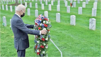  ?? — AFP photo ?? Biden lays a wreath in Arlington National cemetary to honor fallen veterans of Afghan conflict in Arlington, Virginia.