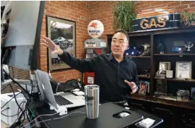  ?? STAFF PHOTO BY MATT HAMILTON ?? Wade Kawasaki works at his desk at the Legendary Coker Tire headquarte­rs in Chattanoog­a on Wednesday.