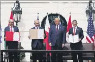  ?? ALEX BRANDON — THE ASSOCIATED PRESS ?? President Donald Trump, center, with from left, Bahrain Foreign Minister Khalid bin Ahmed Al Khalifa, Israeli Prime Minister Benjamin Netanyahu, Trump, and United Arab Emirates Foreign Minister Abdullah bin Zayed al-Nahyan, during the Abraham Accords signing ceremony Tuesday, Sept. 15, on the South Lawn of the White House.