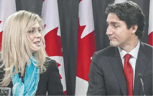  ?? JustinTang / thecanadia­n pres ?? MP Eve Adams, joined by Liberal leader Justin Trudeau, said Monday she is leaving the Tories to join the Liberal party.