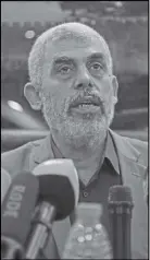  ?? AP PHOTO ?? Yehiyeh Sinwar, the Hamas militant group’s leader in the Gaza Strip, speaks to foreign correspond­ents in his office in Gaza City yesterday,