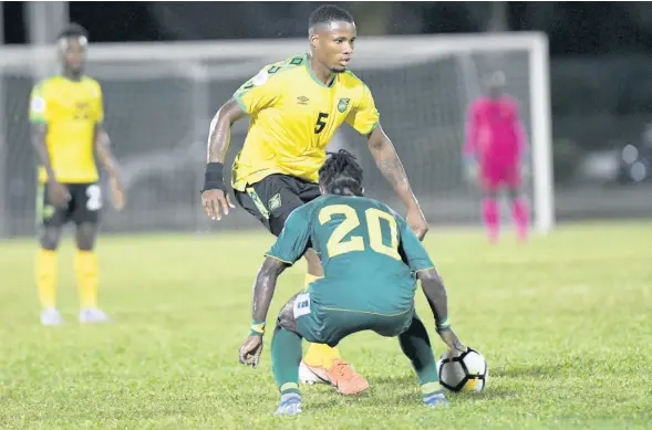  ?? FILE ?? Jamaica’s Alvas Powell attempts to go past Guyana’s Trayon Bobb during a Concacaf Nations League match at the Montego Bay Sports Complex on Novembert 18 last year.