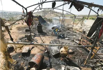  ?? JAAFAR ASHTIYEH/GETTY-AFP ?? A Palestinia­n inspects his damaged belongings Saturday in Al Mughayir in the West Bank.