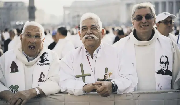  ?? PICTURE: AP ?? 0 Priests wearing vestments with the effigy of martyred Archbishop Oscar Romero attend athecanoni­sation ceremony in St Peter’s Square