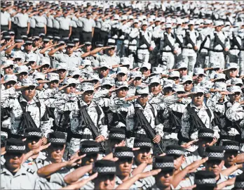  ?? ALFREDO ESTRELLA/GETTY-AFP ?? In Mexico City: The new National Guard force salutes during the ceremony of deployment Sunday in Mexico City. President Manuel Lopez Obrador announced on Thursday that his government will deploy the newly created National Guard in Mexico City.