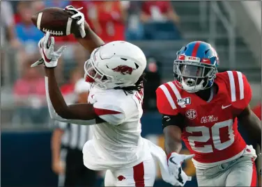  ?? (AP file photo) ?? Arkansas’ Trey Knox (left) and Mike Woods combined to collect 12 catches for 172 yards in a loss at Ole Miss last season. That means nothing for Saturday’s game, Woods said. “So we haven’t made a yard against them this year,” he said. “We still have to go out and earn every yard.”