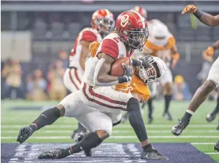  ?? JEFFREY MCWHORTER/ASSOCIATED PRESS ?? Oklahoma punt returner CeeDee Lamb is tackled Saturday in the Big 12 Conference championsh­ip in Arlington, Texas. The Sooners won, 39-27.