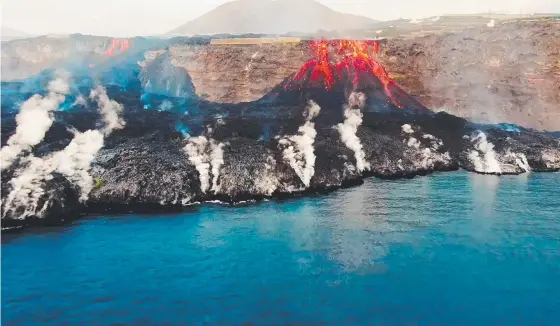  ?? ?? Red-hot magma from the Cumbre Vieja volcano on the Canary Island of La Palma creates a vast rocky delta as it flows into the sea. Picture: AFP