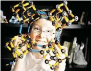  ?? Melissa Phillip / Houston Chronicle ?? Eric Comstock, 9, looks through a model of an Adamantane CC 8 molecule he built. He won Lone Star College’s calculus contest.