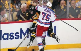  ?? GENE J. PUSKAR - THE ASSOCIATED PRESS ?? New York Rangers’ Ryan Reaves (75) checks Pittsburgh Penguins’ Marcus Pettersson (28) into the boards during the third period in Game 6 on Friday.