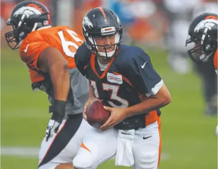  ?? Photos by Andy Cross, The Denver Post ?? Quarterbac­k Trevor Siemian had one edge in Saturday’s scrimmage — he didn’t turn over the ball.