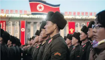  ?? KIM WON- JIN/AFP/ GETTY IMAGES ?? North Korean soldiers attend a mass rally on Friday in Pyongyang to celebrate the country’s declaratio­n two days earlier that it had achieved full nuclear statehood. North Korea tested an ICBM on Wednesday.