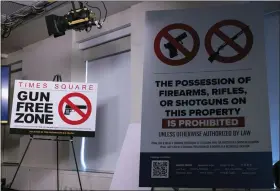  ?? YUKI IWAMURA/THE ASSOCIATED PRESS ?? “Gun Free Zone” signs, which are expected to be installed at Times Square, are seen during a news conference Wednesday in New York.