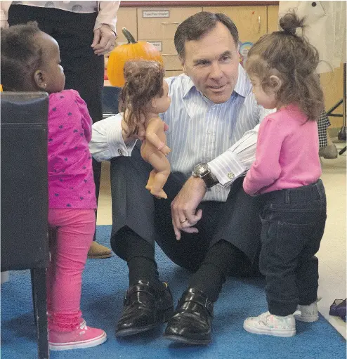  ?? ADRIAN WYLD / THE CANADIAN PRESS ?? Finance Minister Bill Morneau at a daycare centre Wednesday. The perception that politician­s are only in it for themselves has reached ludicrous levels, John Ivison writes.