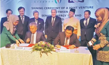  ??  ?? Jefri (seated, right) and Chaiwat signing the JVA witnessed by Awang Tengah (standing, centre) and Morshidi (on Awang Tengah’s left).