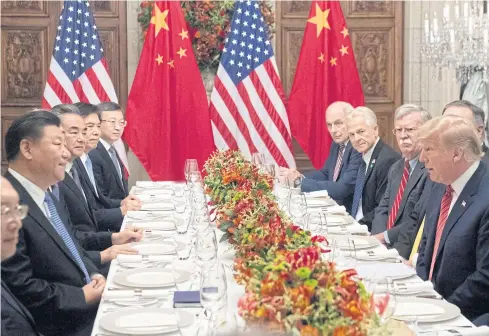  ?? AFP ?? US President Donald Trump, right, and China’s President Xi Jinping, left, along with members of their delegation­s, have dinner at the end of the G-20 Leaders’ Summit in Buenos Aires on Saturday.