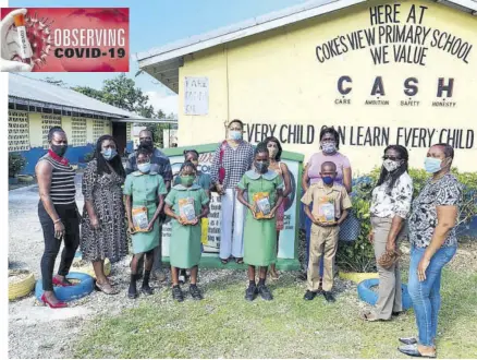  ??  ?? Representa­tives of Youth For Tech, parents and Coke’s View Primary School staff (back row) join students of the school who were recently presented with tablets to facilitate online learning.