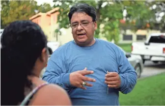  ?? PHOTOS BY DANIELLE PARHIZKARA­N, NORTHJERSE­Y.COM, VIA USA TODAY NETWORK ?? Advocate Robert Rodriguez acts as a translator and helps fill out FEMA forms for immigrants whose homes in Houston have been damaged by flooding after Hurricane Harvey.