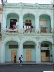  ?? THE ASSOCIATED PRESS ?? In this May 17, 2015 photo, air dried laundry hang from makeshift clotheslin­es on balconies in Old Havana, Cuba. In some destinatio­ns, tourist areas are located far from the rhythms of everyday life. But But visitors who wander through Old Havana will...