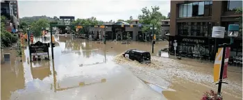  ?? Stuart Gradon/Postmedia News/File ?? A police van drives through a flooded intersecti­on in Calgary’s Mission neighbourh­ood.