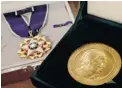  ?? RICHARD DREW/ THE ASSOCIATED PRESS ?? Rosa Parks’ medal of freedom, left, and her Congressio­nal Gold Medal are shown at a New York auction house.